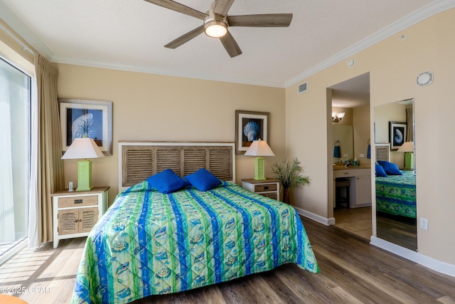 bedroom with baseboards, ornamental molding, a ceiling fan, visible vents, and wood finished floors