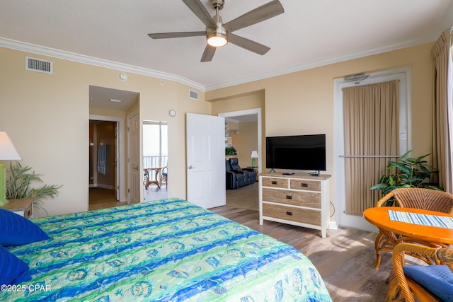 bedroom with visible vents, ceiling fan, ornamental molding, and wood finished floors