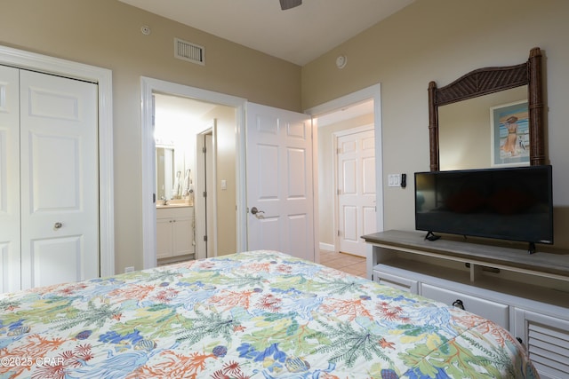 bedroom featuring visible vents, tile patterned floors, and a closet