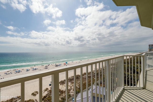 balcony featuring a beach view and a water view