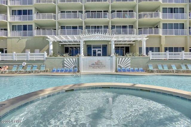 community pool with a community hot tub