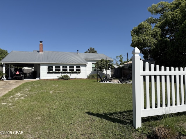 1404 Chestnut Ave, Panama City, FL 32401 - exterior space featuring metal roof, a front yard, fence, concrete driveway, and an attached carport