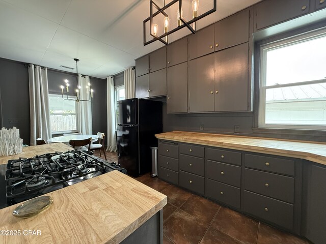 1404 Chestnut Ave, Panama City, FL 32401 - kitchen featuring butcher block counters, gray cabinetry, freestanding refrigerator, and a chandelier