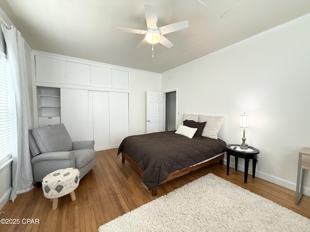 1404 Chestnut Ave, Panama City, FL 32401 - bedroom with crown molding, ceiling fan, a closet, wood finished floors, and baseboards