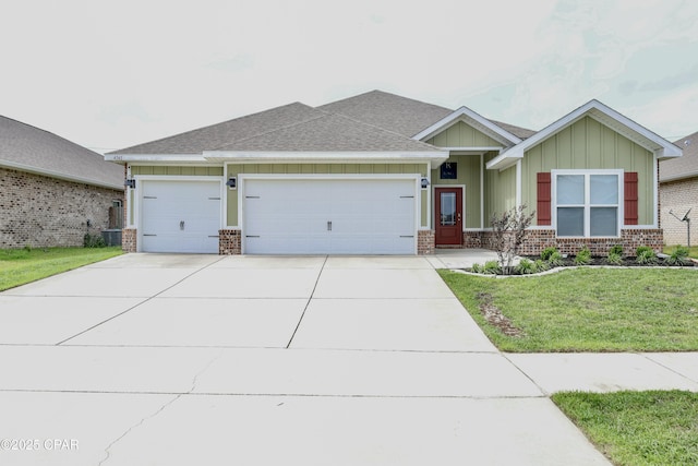 view of front facade featuring board and batten siding, driveway, brick siding, an attached garage, and a front lawn