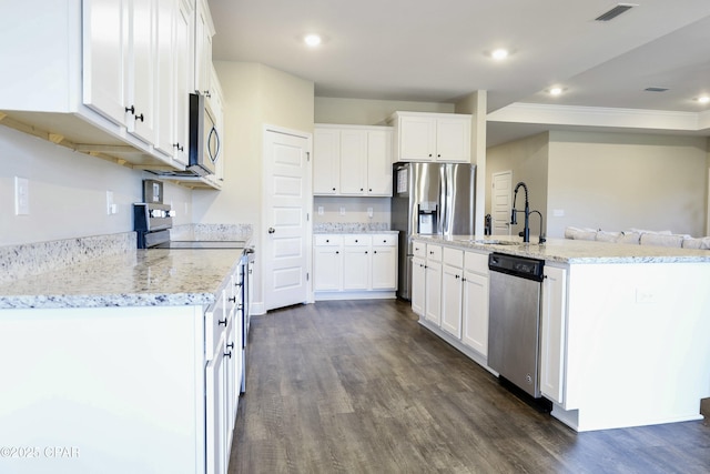 kitchen featuring white cabinetry, appliances with stainless steel finishes, dark wood-type flooring, and a sink