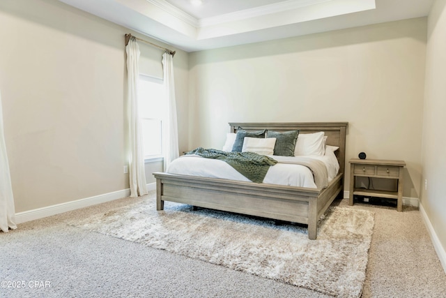 bedroom featuring a tray ceiling, carpet flooring, baseboards, and ornamental molding