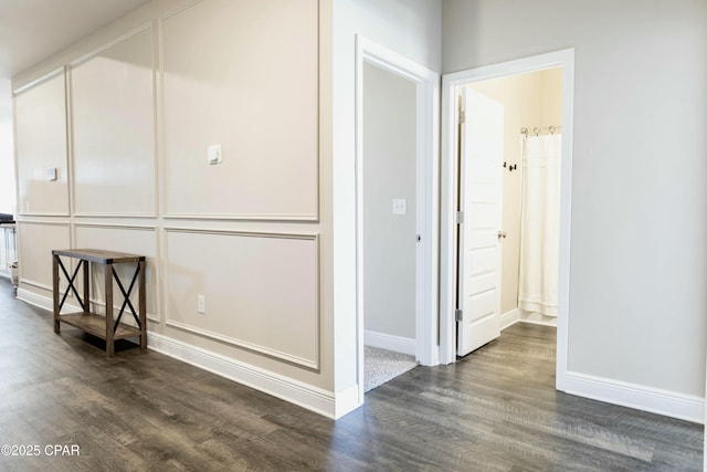 interior space with dark wood-style flooring and baseboards