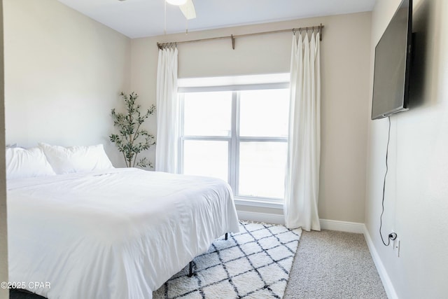 bedroom with carpet, baseboards, and a ceiling fan