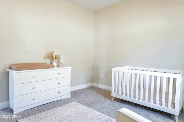 carpeted bedroom featuring baseboards and a crib