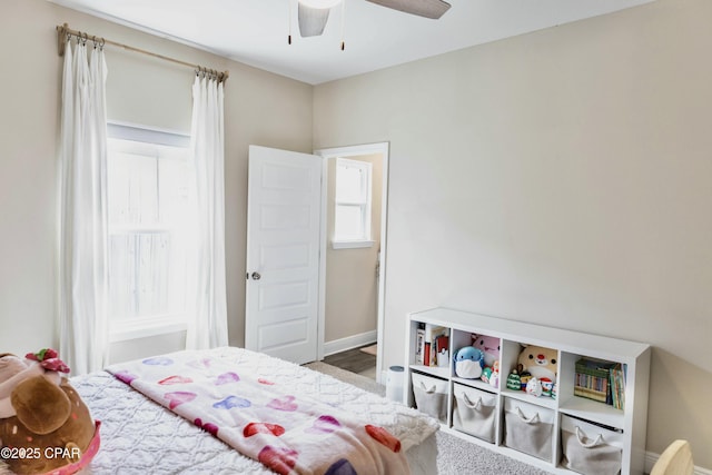 bedroom with multiple windows, baseboards, and ceiling fan