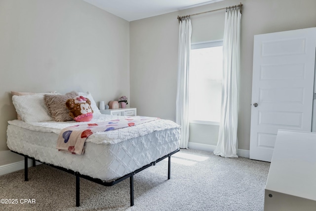 bedroom featuring carpet, baseboards, and multiple windows