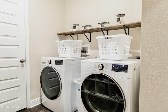 laundry area featuring separate washer and dryer, laundry area, and dark wood-style flooring