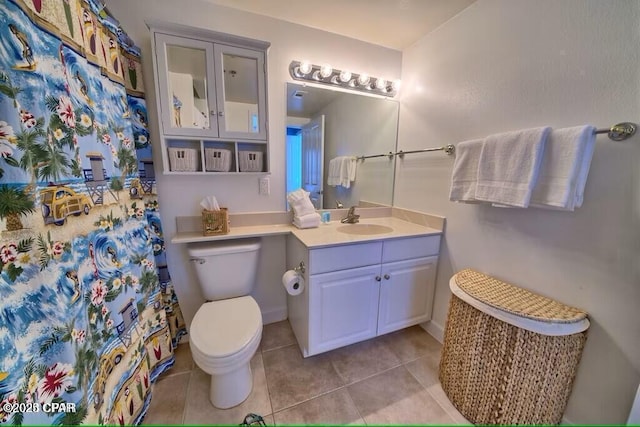 bathroom featuring toilet, vanity, and tile patterned flooring