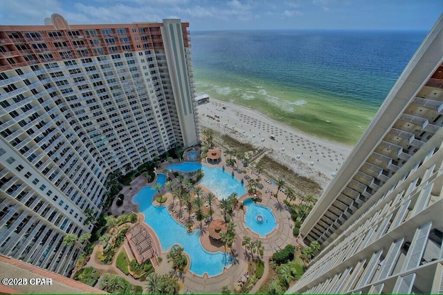 bird's eye view with a water view and a beach view