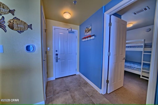 interior space featuring tile patterned floors, baseboards, and visible vents