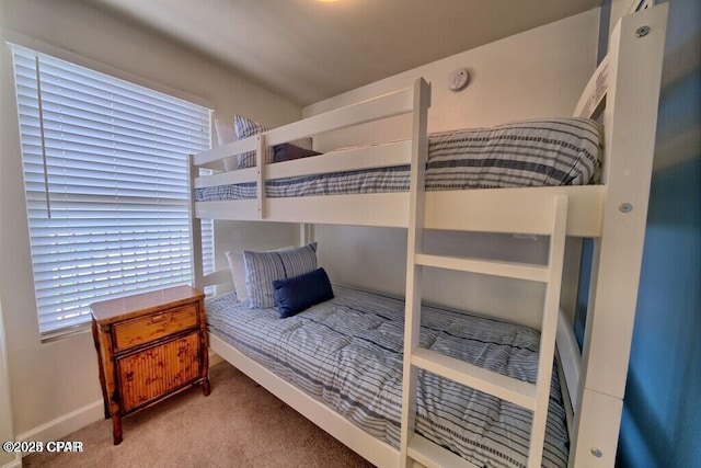 bedroom with carpet and baseboards