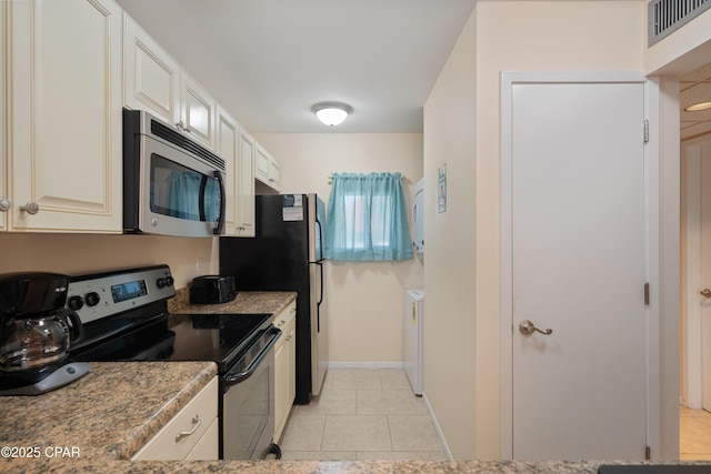 520 N Richard Jackson Blvd Unit 2209, Panama City Beach, FL 32407 - kitchen featuring light tile patterned floors, baseboards, visible vents, and stainless steel appliances