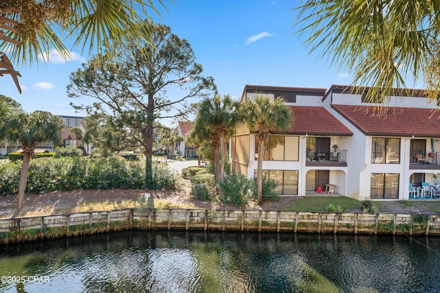 520 N Richard Jackson Blvd Unit 2209, Panama City Beach, FL 32407 - rear view of house featuring a tiled roof, stucco siding, a water view, a patio area, and a balcony