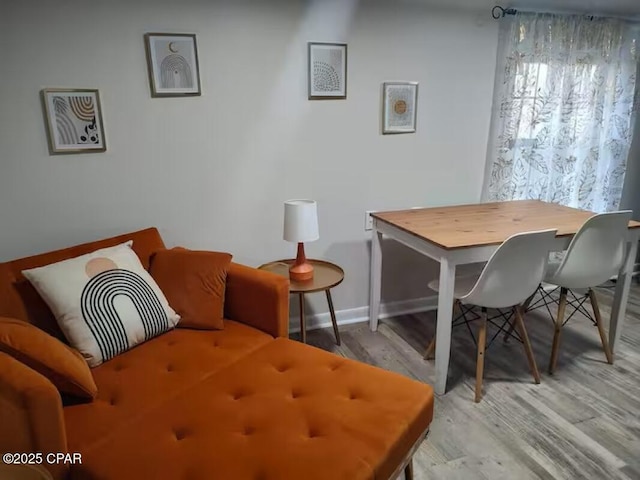 dining room with baseboards and light wood-type flooring