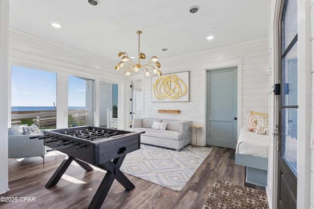 12401 Front Beach Rd, Panama City Beach, FL 32407 - game room featuring ornamental molding, recessed lighting, an inviting chandelier, and wood finished floors