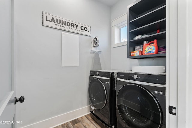 12401 Front Beach Rd, Panama City Beach, FL 32407 - washroom featuring baseboards, wood finished floors, separate washer and dryer, and laundry area