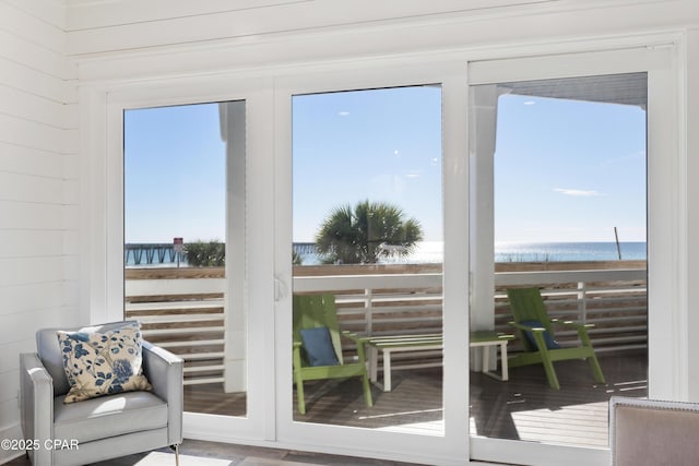 12401 Front Beach Rd, Panama City Beach, FL 32407 - doorway with a water view, wood walls, and a wealth of natural light