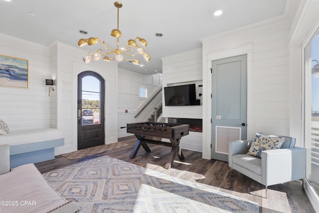12401 Front Beach Rd, Panama City Beach, FL 32407 - entryway featuring crown molding, arched walkways, visible vents, wood finished floors, and a notable chandelier