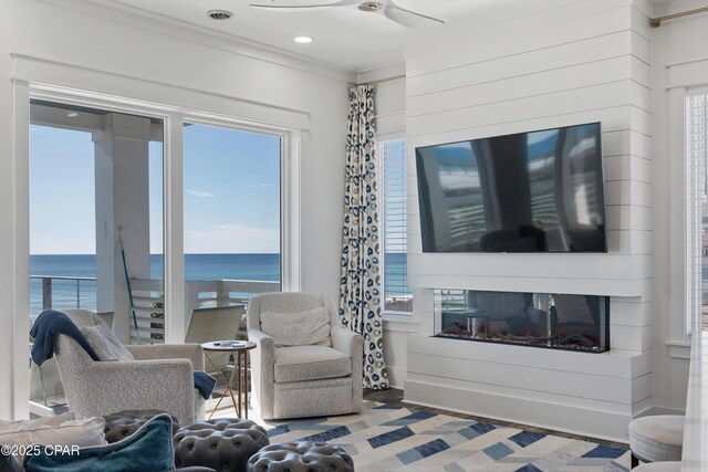 12401 Front Beach Rd, Panama City Beach, FL 32407 - sitting room featuring crown molding, ceiling fan, a fireplace, and a wealth of natural light