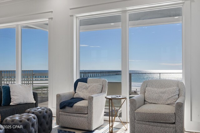 12401 Front Beach Rd, Panama City Beach, FL 32407 - sitting room featuring a healthy amount of sunlight, a beach view, and a water view