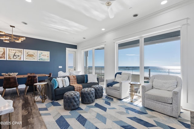 12401 Front Beach Rd, Panama City Beach, FL 32407 - living area with ornamental molding, recessed lighting, a chandelier, a water view, and wood finished floors
