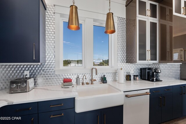 12401 Front Beach Rd, Panama City Beach, FL 32407 - kitchen with tasteful backsplash, glass insert cabinets, a sink, pendant lighting, and blue cabinets
