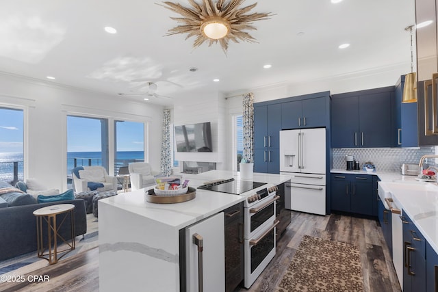12401 Front Beach Rd, Panama City Beach, FL 32407 - kitchen with dark wood-style flooring, high quality appliances, open floor plan, blue cabinetry, and a kitchen island
