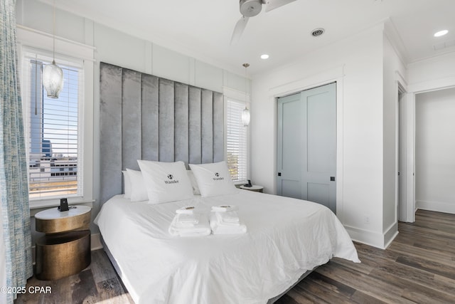 12401 Front Beach Rd, Panama City Beach, FL 32407 - bedroom featuring a closet, baseboards, ornamental molding, dark wood-style floors, and recessed lighting