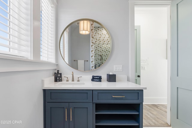 12401 Front Beach Rd, Panama City Beach, FL 32407 - bathroom featuring baseboards, vanity, and wood finished floors