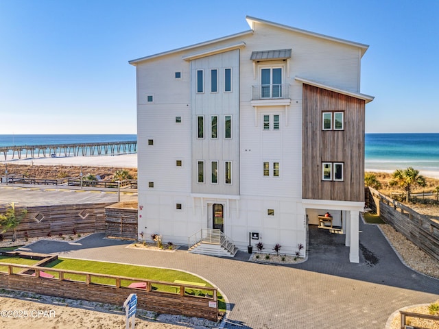 12401 Front Beach Rd, Panama City Beach, FL 32407 - exterior space featuring a water view, a beach view, decorative driveway, and fence