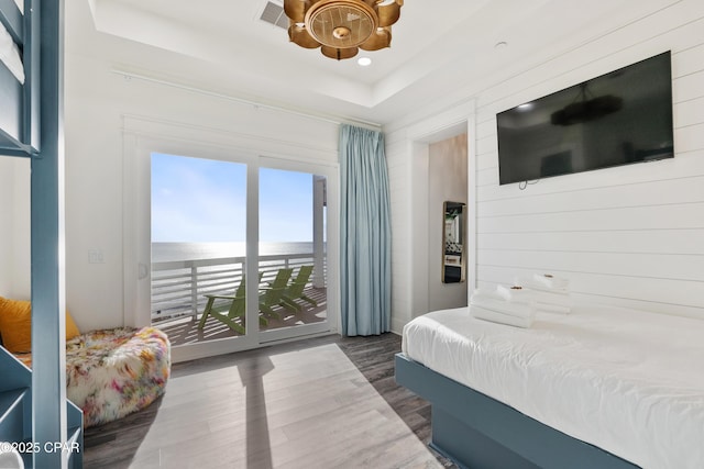 12401 Front Beach Rd, Panama City Beach, FL 32407 - bedroom with a tray ceiling, visible vents, recessed lighting, access to exterior, and wood finished floors