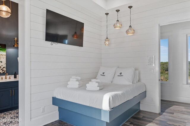 12401 Front Beach Rd, Panama City Beach, FL 32407 - bedroom featuring a sink, dark wood-style floors, baseboards, and connected bathroom