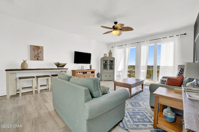 9902 S Thomas Dr Unit 629, Panama City, FL 32408 - living room featuring light wood-style flooring and ceiling fan