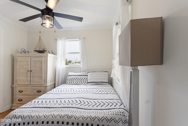 bedroom featuring ornamental molding, ceiling fan, and wood finished floors