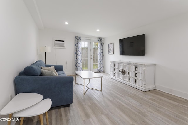living room featuring recessed lighting, baseboards, a wall unit AC, and wood finished floors