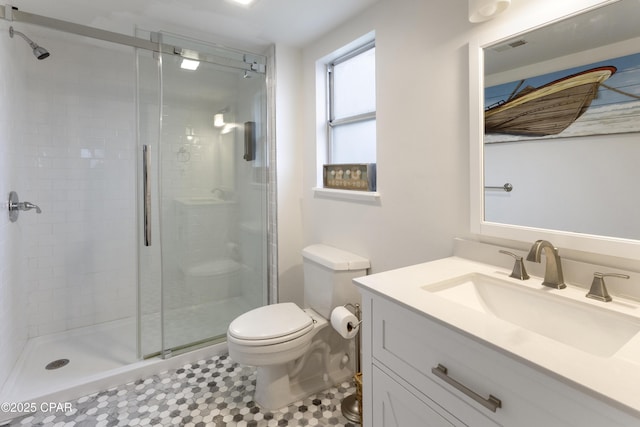 full bath with vanity, toilet, and a stall shower
