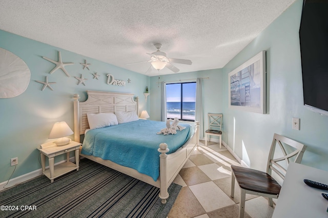 8610 Surf Dr Unit 306, Panama City Beach, FL 32408 - bedroom with a textured ceiling and a ceiling fan