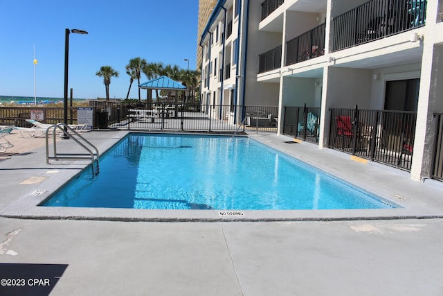8610 Surf Dr Unit 306, Panama City Beach, FL 32408 - community pool with a patio area