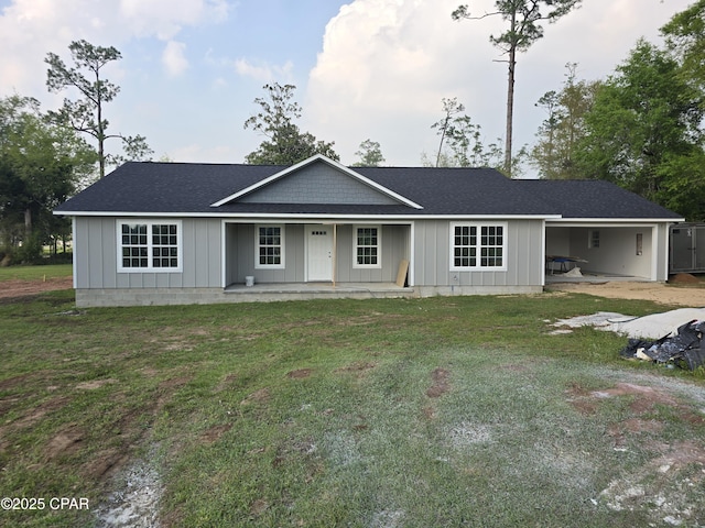 4610 Pineview Dr, Marianna, FL 32446 - ranch-style home featuring a porch, a front lawn, a shingled roof, and board and batten siding