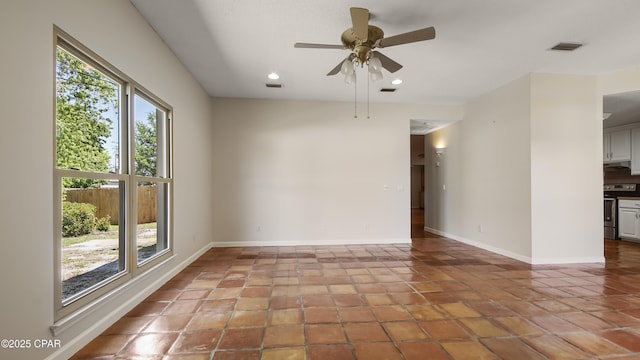 tiled empty room featuring recessed lighting, visible vents, baseboards, and a ceiling fan
