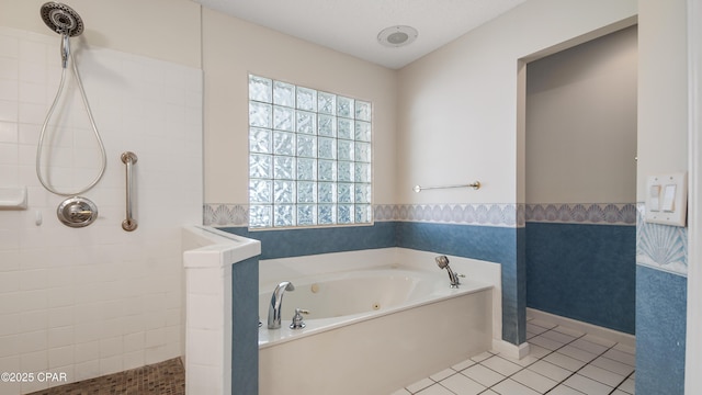 full bathroom featuring a bath, tile patterned floors, baseboards, and a tile shower