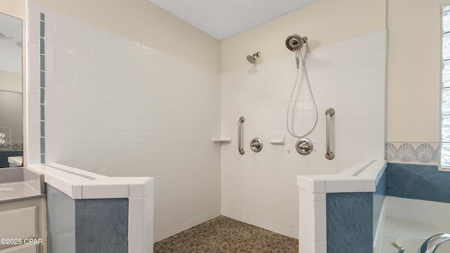 bathroom featuring walk in shower and vanity
