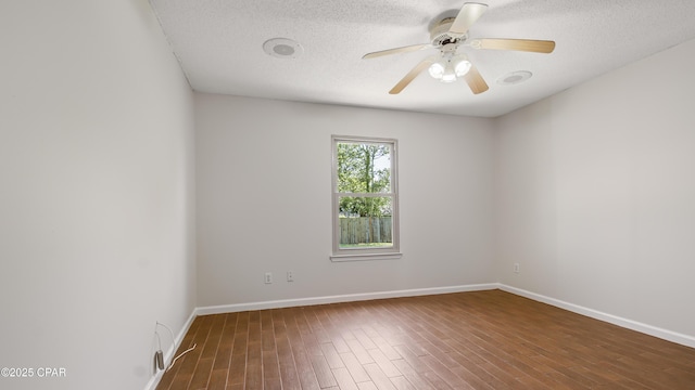 unfurnished room featuring a textured ceiling, wood finished floors, ceiling fan, and baseboards