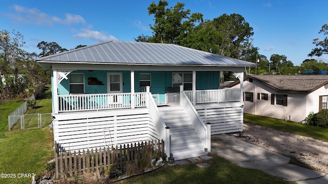 1314 Mcclelland Ave, Port St Joe, FL 32456 - view of front of house with a porch, stairway, and metal roof